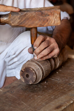 Hands carving a wooden piece with a mallet and chisel, Jammu and Kashmir, Srinagar, India