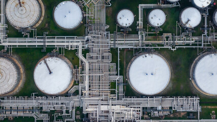 Obraz na płótnie Canvas Aerial view oil and gas refinery petrochemical storage tank and pipeline steel, Oil and gas transportation system pipeline steel at oil and gas refinery industry chemical plant, Pipeline oil and gas.