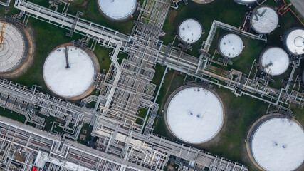 Obraz na płótnie Canvas Aerial view oil and gas refinery petrochemical storage tank and pipeline steel, Oil and gas transportation system pipeline steel at oil and gas refinery industry chemical plant, Pipeline oil and gas.