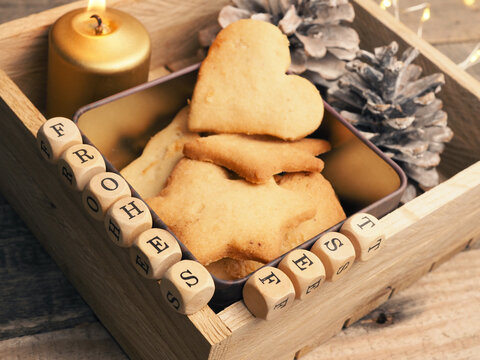 Small wooden block with the German words Frohes Fest and Christmas decoration