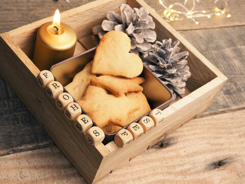 Small wooden block with the German words Frohes Fest and Christmas decoration