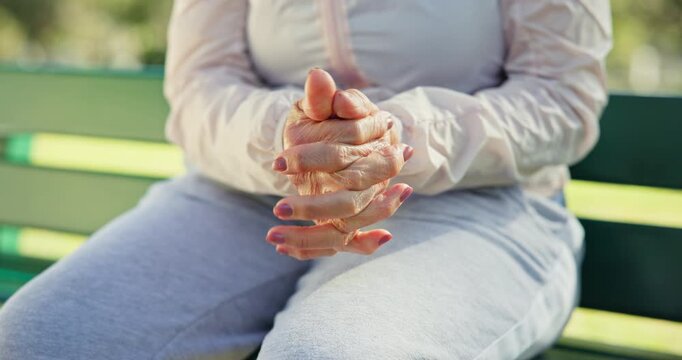 Senior, woman and itching with hands together on park bench for dry skin condition or irritation. Elderly, female person or rub with eczema for health xerosis, outdoor aging or dermatitis in nature