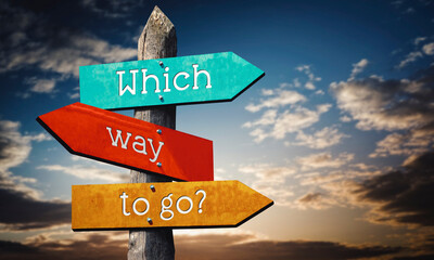 Which way to go - colorful wooden signpost with three arrows, sunset sky © PX Media