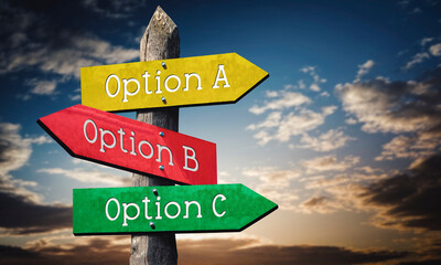 Option A, B or C - colorful wooden signpost with three arrows, sunset sky © PX Media
