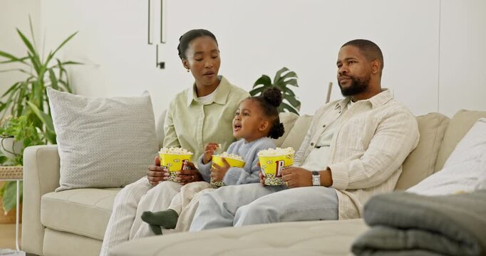 Parents, child and watching tv in house with popcorn, bonding together and quality time on weekend. Black people, father and mother talk on sofa with daughter, corn snack and family streaming film.