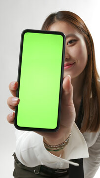Young Asian Woman Showing Smartphone with Green Screen Mockup