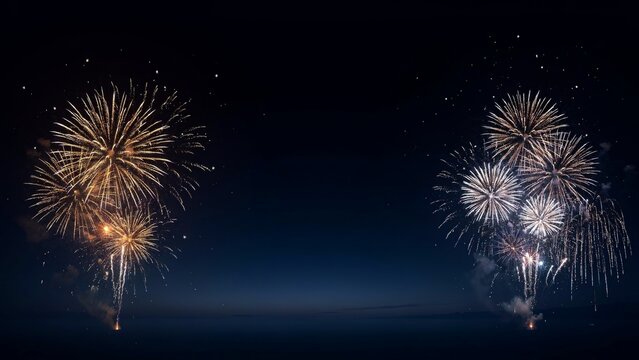 golden and silver New Year fireworks illuminating a dark navy blue night sky with panoramic copy space