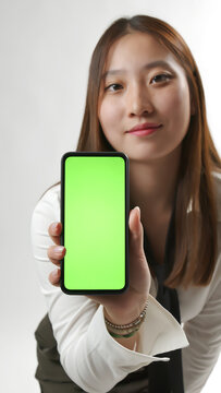 Smiling Young Asian Woman Showing Smartphone Green Screen Mockup