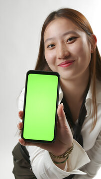 Smiling Young Asian Woman Showing Smartphone Green Screen Mockup