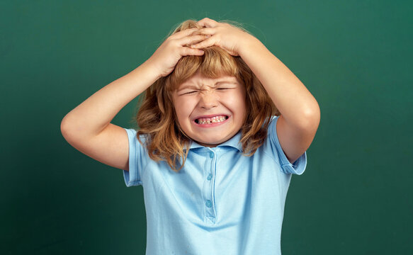Children's whims, tantrums. Headache. Boy touching head and have a migraine