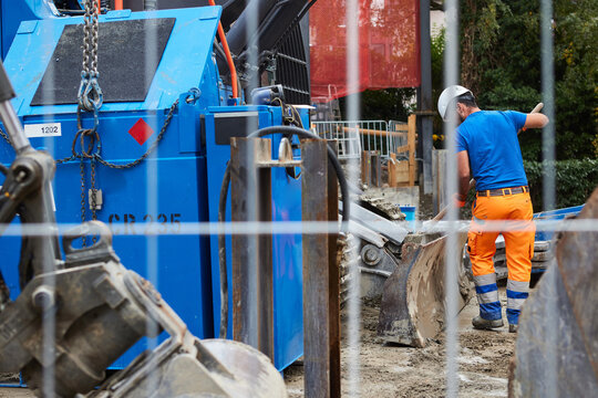     Go to Page|12345Next

Construction worker handling wet concrete at a building site, using a shovel beside concrete pumping equipment and a construction mixer. Industrial machinery and concrete han