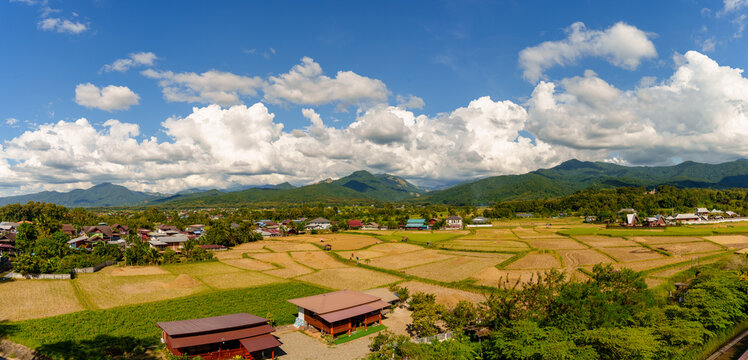 Panoramic View of Agricultural Fields and Village Under Blue Sky with Clouds in Northern Thailand