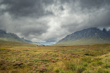The moorlands of Glencoe along the West Highland Way in Scotland with the River Etive Bridge and Buachaille Etive Mor mountain shrouded in cloud in the distance © Jon Ingall