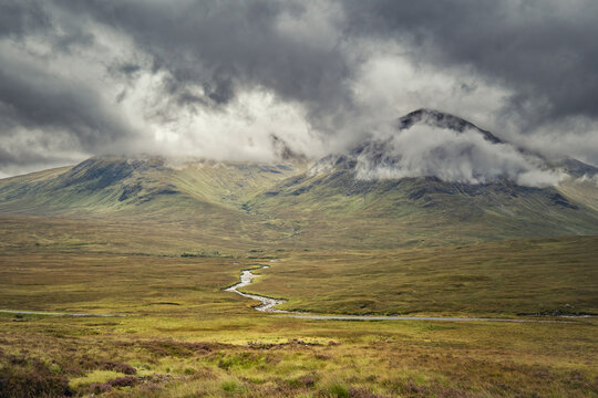 The river Coupall comes down from the mountains and winds its way along the Glencoe valley in the Highlands of Scotland