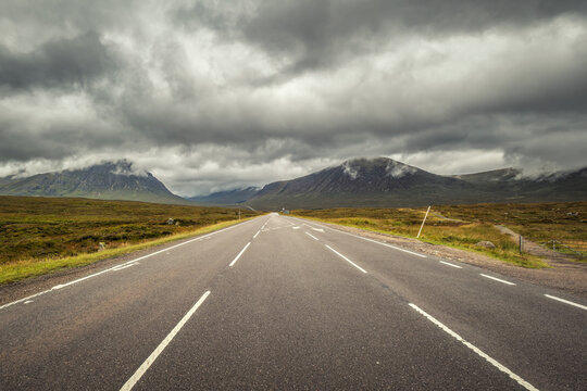 The A82 through Glencoe is a picturesque road surrounded by mountains heading into the Highlands of Scotland with Buachaille Etive Mor on the left and Beinn a'Chrulaiste to the right