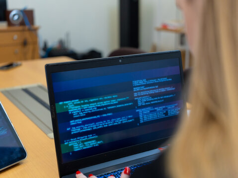 Programmer or IT pointing to code cybersecurity on laptop at home office for concept verifying code algorithm. Employees woman write code, typing on computer for software development. Remote work.