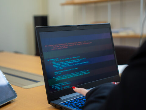 Programmer or IT pointing to code cybersecurity on laptop at home office for concept verifying code algorithm. Employees woman write code, typing on computer for software development. Remote work.