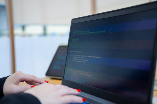 Programmer or IT pointing to code cybersecurity on laptop at home office for concept verifying code algorithm. Employees woman write code, typing on computer for software development. Remote work.