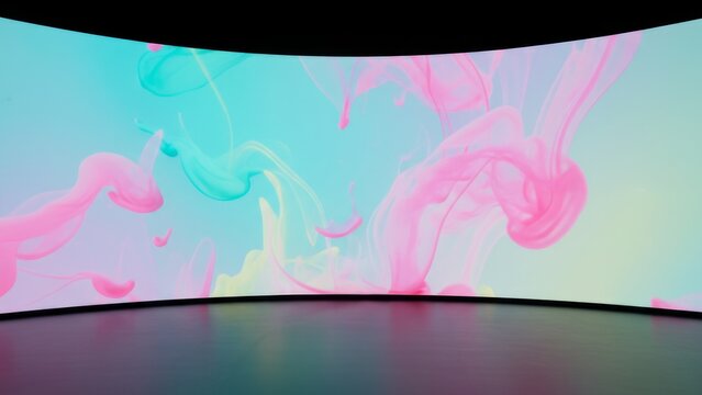 Curved LED screen display with colorful pastel ink in water fluid art background on stage