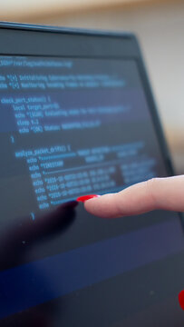 Programmer or IT pointing to code cybersecurity on laptop at home office for concept verifying code algorithm. Employees woman write code, typing on computer for software development. Remote work.