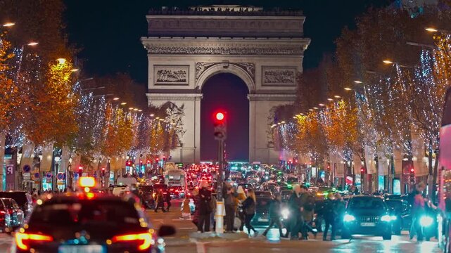 Christmas street decoration. Building, trees in garlands. Paris France. Christmas light illuminated at night during the Christmas season in centre Paris. Crow of people