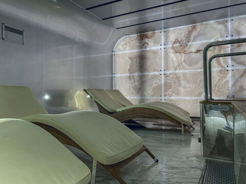 Thermal suite relaxation room loungers or chairs in spa or wellness area on modern luxury cruiseship or cruise ship ocean liner in clean modern design