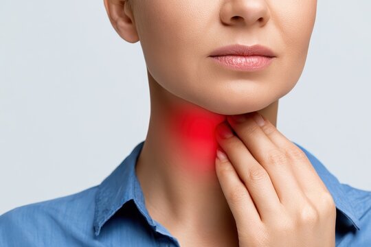 Woman touches neck to thyroid gland disease symptoms. Glowing red sign on throat. Endocrine inflammation hypothyroidism goiter node or larynx pain. Lymph node screening, hormones. Awareness campaign