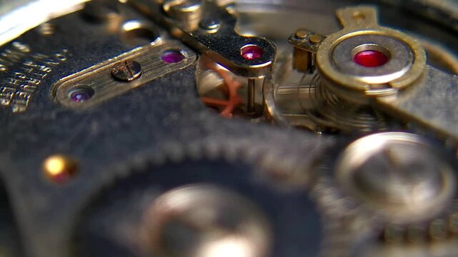 Close up macro video of vintage mechanical watch movement gears and jewels ticking
