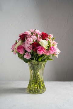Mixed rose and carnation bouquet in a glass vase