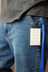 Plakat Identification badge clipped to jeans near hip with lanyard