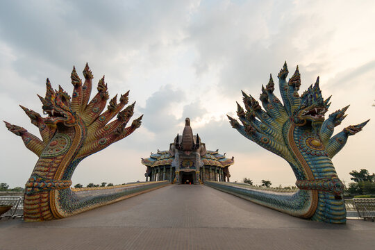 Grand multi headed naga snake statues guarding bridge walkway to temple