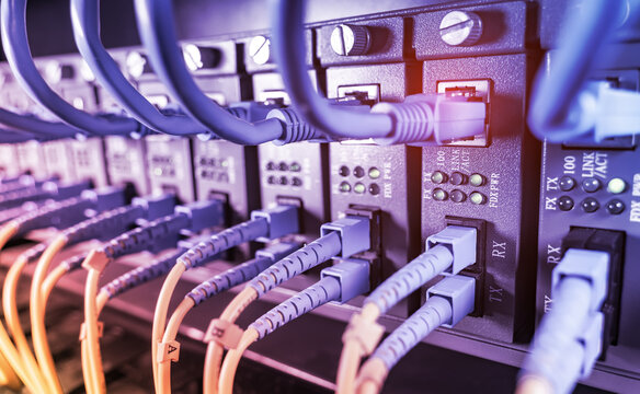 Fiber Optic cables connected to optic ports and UTP, Network cables connected to ethernet ports.