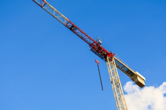 Construction crane operating against clear blue sky