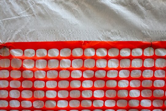 Orange safety net creating abstract grid pattern