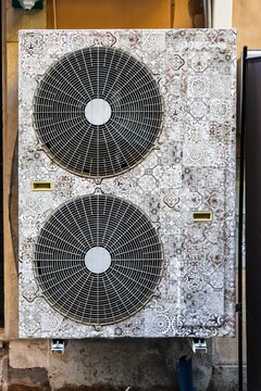 Air conditioning unit featuring decorative patterned facade in Rome