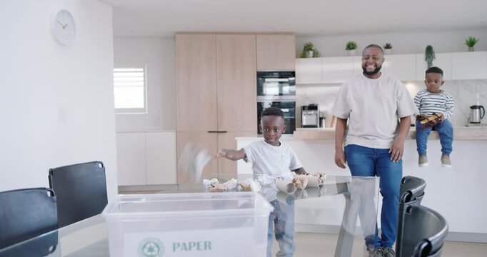 African American family in kitchen father clapping encouraging boy throwing balls into PAPER bin