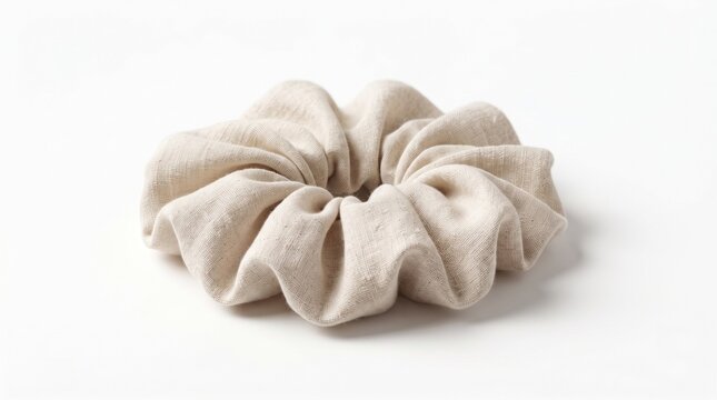 cream fabric scrunchie isolated on clean background representing minimalist hair styling, soft textile accessories and everyday beauty essentials concept