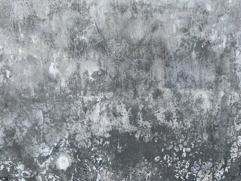 Abstract dark grey concrete wall texture with weathered cement patterns, cracks, and industrial grunge background style