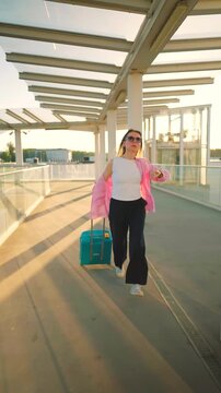 Caucasian woman pulling a suitcase and running, late for flight. 