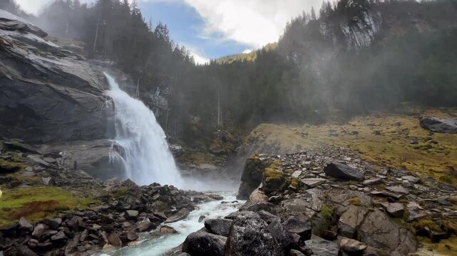 Fallbach mountain waterfall pouring over dark rock. Autumn in Austria.