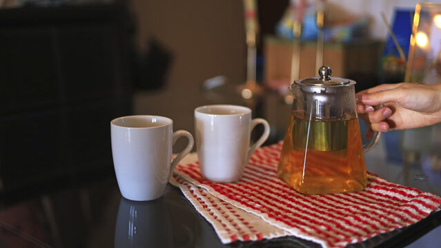 Glass teapot and ceramic white mugs, beverage service and hospitality tableware for brewing and serving tea at home