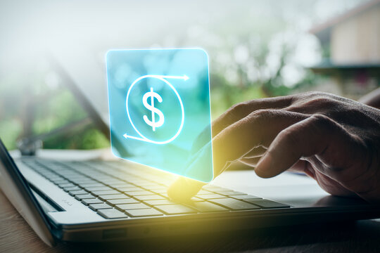 Businessman typing on laptop with digital dollar sign currency exchange and money transfer interface overlay in outdoor setting, concept of financial technology, cashback, and online banking.