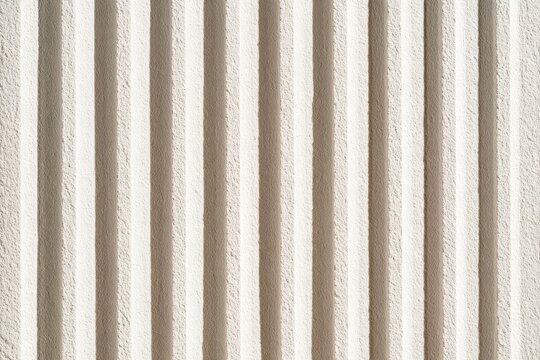 Fluted stone texture with vertical parallel ridges in a macro shot for modern interior design and architectural branding