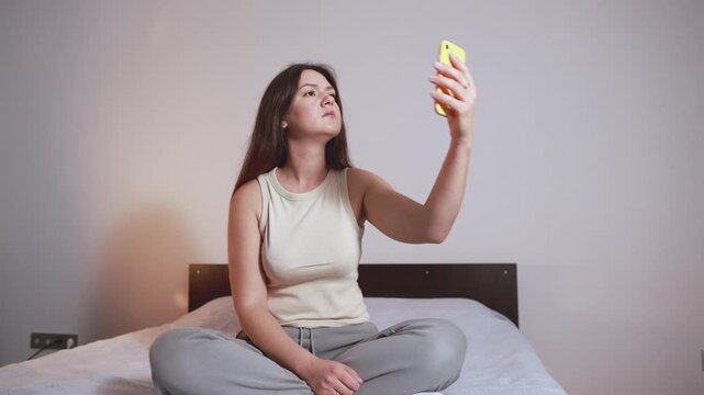 Woman checks her smartphone while searching for stable internet connection at home. Network failure interrupts her routine and leaves her unable to get online.