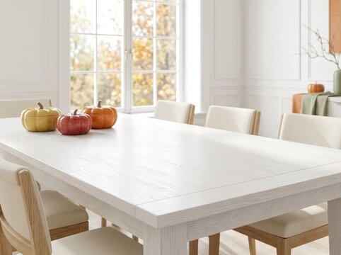 An elegant white wooden dining table, decorated with yellow, red, and orange pumpkins, in a bright, minimalist dining room. Cozy autumn interior filled with natural light.