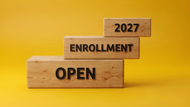 Open enrollment 2027 wooden block steps, admission registration concept on yellow background, education and insurance application process