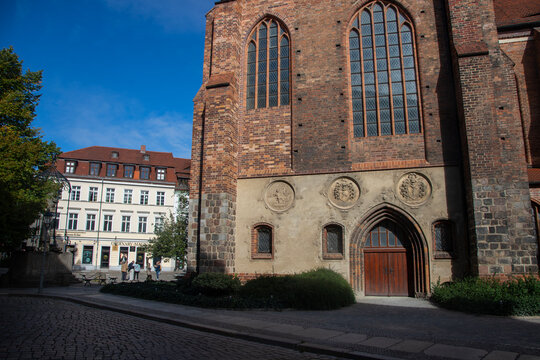 Low-angle view of the historic red-brick Nikolaikirche tower in Berlin's Nikolai Quarter