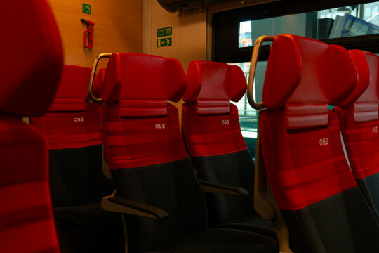 Vienna, Austria - September 21, 2026: Empty red seats with the OBB logo inside a passenger car of an Austrian Federal Railways train.