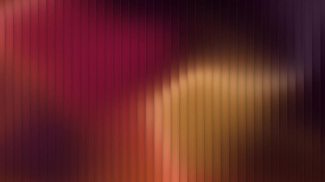 Warm crimson and amber light drifting behind fluted glass