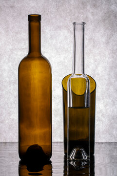 Still life with glass bottles against a gray background